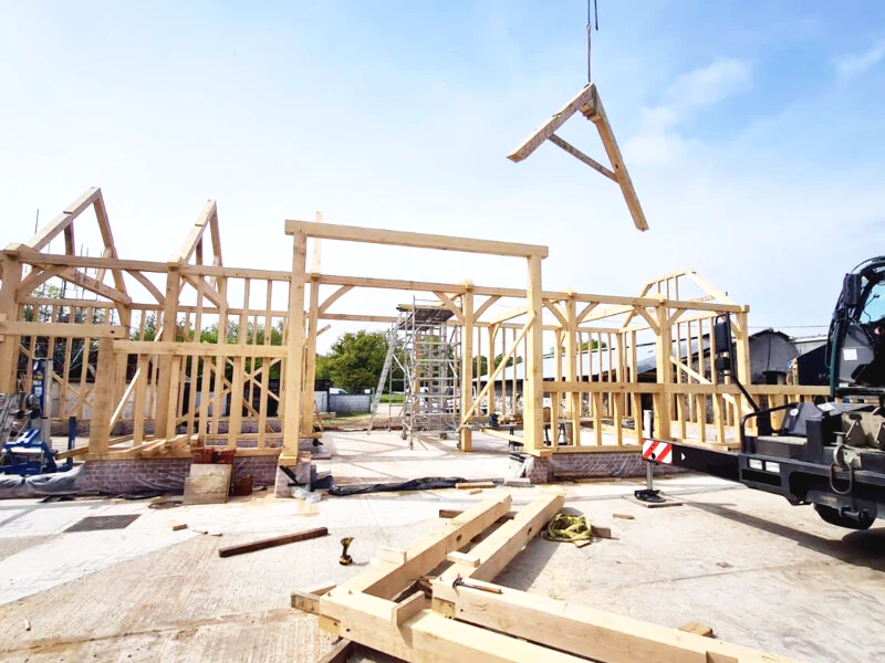 Oakcraft oak framed barn construction in progress, showcasing timber frame assembly.