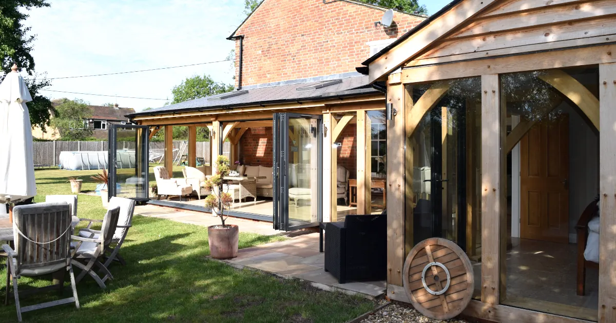 Bespoke Oak Framed Buildings In Berkshire Bespoke oak framed buildings in Berkshire: Contemporary oak framed garden room in featuring full-width bi-fold doors, exposed oak posts, covered veranda