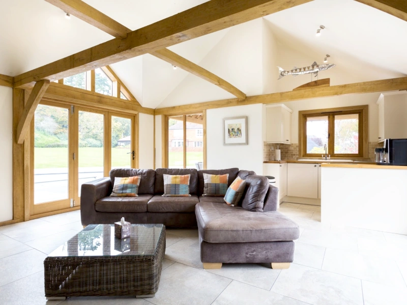 Bespoke oak-framed garden annexe by oakcraft, designed as a multigenerational living space with kitchen and lounge.