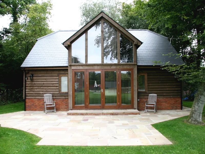 Bespoke oak-framed garden annexe by oakcraft, ideal for a wellness retreat or home gym with a serene atmosphere.