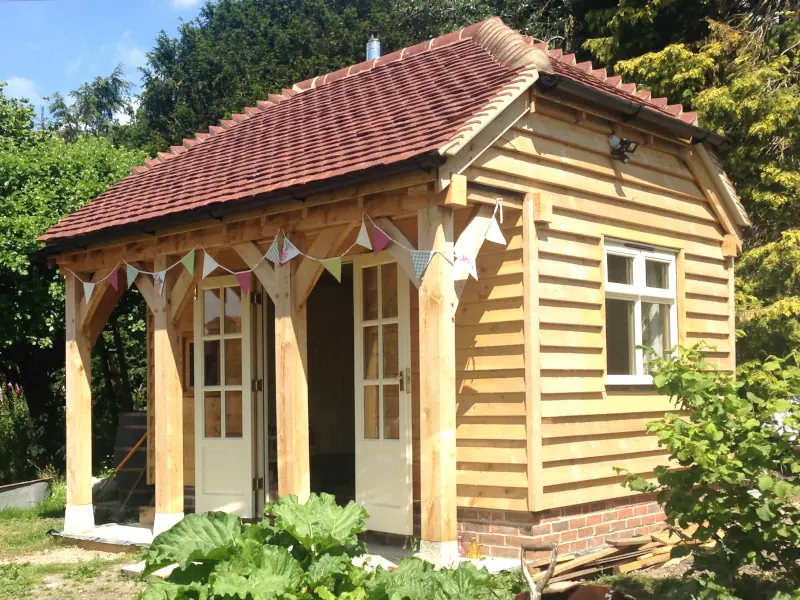 Charming bespoke oak-framed garden annexe by oakcraft, perfect as a cosy outdoor retreat.