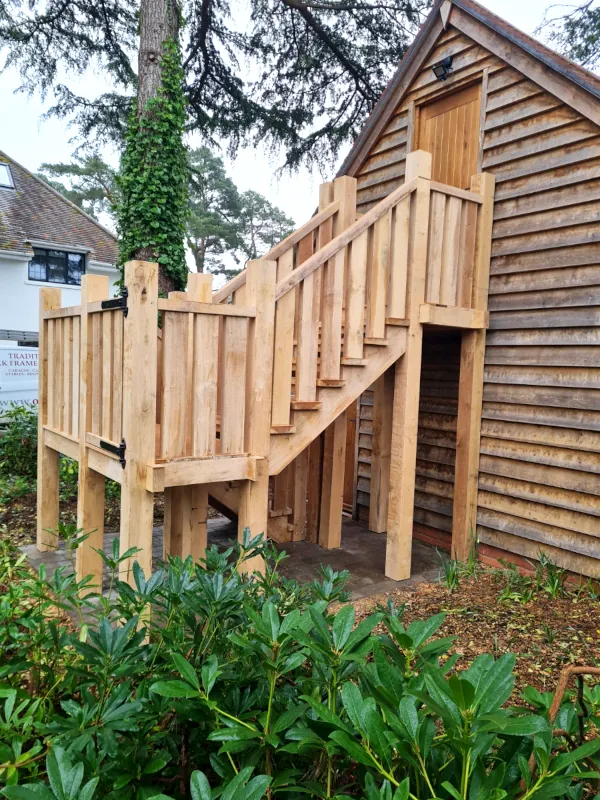 Bespoke external oak staircase for garage loft access in dorset featuring traditional joinery and feather-edge cladding