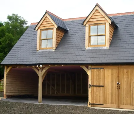 Double-bay oak carport with integrated garage and room above, crafted by oakcraft