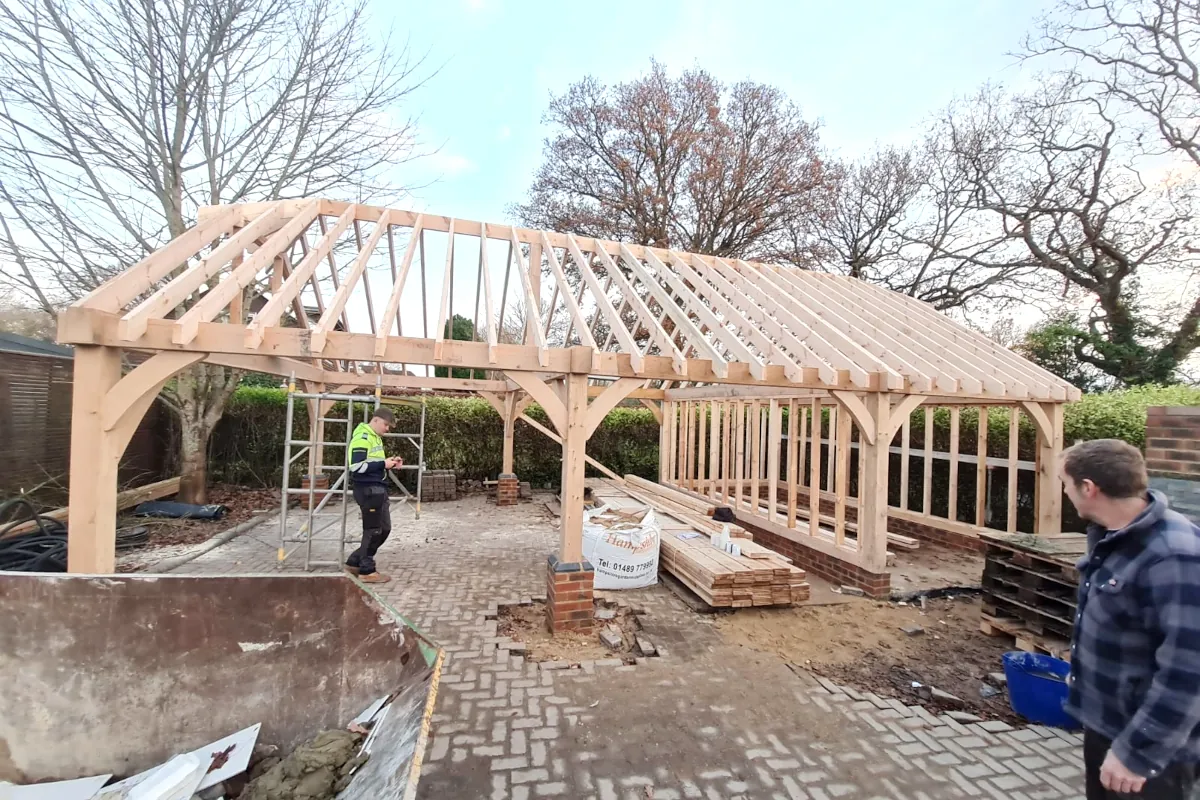 Detached oak frame garage under construction in warsash, showing timber frame and roof structure assembly by local hampshire craftsmen