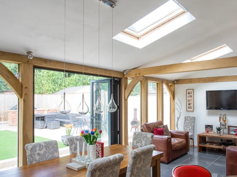 Modern oak extension for more living space,with dining and kitchen area, featuring skylights, bifold doors and open-plan layout