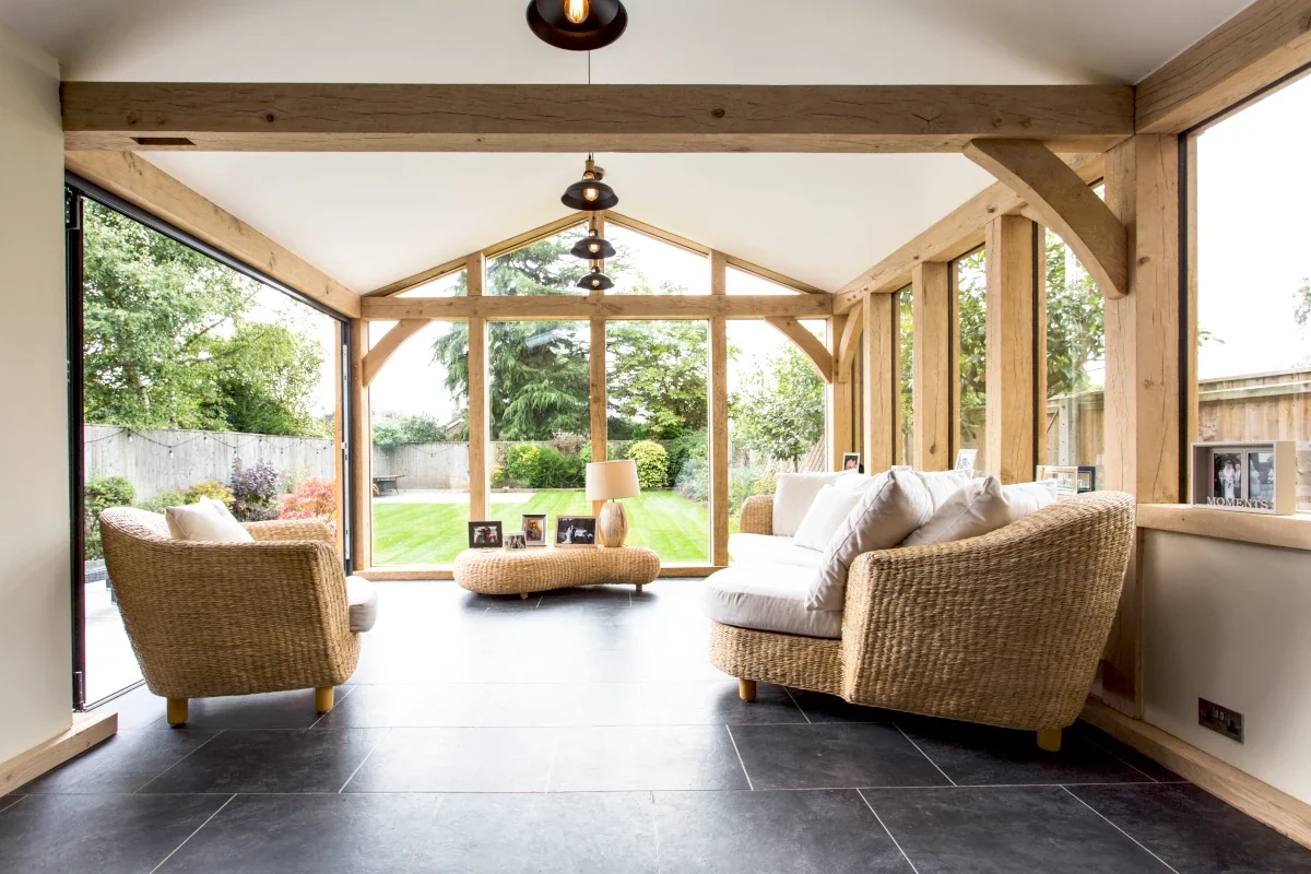 A Hampshire bright and airy oak extension with sleek aluminium bifold doors, one of the versatile oak framed garden rooms we built in the UK
